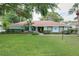 Beautiful one-story home boasts lush green grass and landscaping at 255 Lake Link Rd, Winter Haven, FL 33884