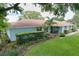 Beautiful one-story home boasts lush green grass and landscaping at 255 Lake Link Rd, Winter Haven, FL 33884
