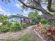Charming front yard features lush vegetation, stone path, and views of the home at 255 Lake Link Rd, Winter Haven, FL 33884