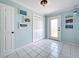 Hallway with tiled floor, multiple doors, closet and artwork, providing seamless transition between spaces at 255 Lake Link Rd, Winter Haven, FL 33884