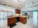 Open kitchen and breakfast bar with wooden cabinets and easy flow between dining and living spaces at 255 Lake Link Rd, Winter Haven, FL 33884