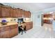 Kitchen area with ample wood cabinets, workstation, tile floors, and lots of counter space at 255 Lake Link Rd, Winter Haven, FL 33884
