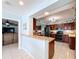 Bright kitchen featuring a breakfast bar that opens into living room, stainless appliances, and tile floors at 255 Lake Link Rd, Winter Haven, FL 33884
