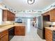 Modern kitchen with stainless steel appliances, ample counter space, tiled flooring, and seamless flow to living areas at 255 Lake Link Rd, Winter Haven, FL 33884