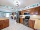 Bright and spacious kitchen featuring stainless steel appliances, a breakfast bar, and an adjacent home office space at 255 Lake Link Rd, Winter Haven, FL 33884