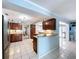 Bright, open kitchen layout with wood cabinets, tiled floors, breakfast bar, and seamless flow to other living spaces at 255 Lake Link Rd, Winter Haven, FL 33884