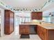 Well-equipped kitchen featuring wooden cabinets, easy access to dining area, and tiled floor at 255 Lake Link Rd, Winter Haven, FL 33884