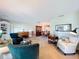 Spacious living room with comfortable seating, a piano, and view into the dining room at 255 Lake Link Rd, Winter Haven, FL 33884