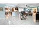 Open living room featuring tiled floors, comfortable seating, and seamless flow to kitchen and dining areas at 255 Lake Link Rd, Winter Haven, FL 33884