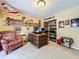 Home office featuring a decorative desk, comfortable seating, and built-in shelving with personal collections at 255 Lake Link Rd, Winter Haven, FL 33884