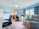Bright office with built in desks, ceiling fan, chair and an easy access to a bathroom at 255 Lake Link Rd, Winter Haven, FL 33884