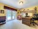 Bright home office featuring a decorative desk, comfortable seating, and pool views through French doors at 255 Lake Link Rd, Winter Haven, FL 33884