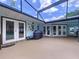 Enclosed patio with grill, ceiling and blue walls leading to the swimming pool area at 255 Lake Link Rd, Winter Haven, FL 33884