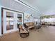 Enclosed patio featuring couches and chairs leading to the swimming pool area at 255 Lake Link Rd, Winter Haven, FL 33884