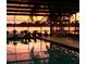 Screened-in pool at dusk with string lights and water view at 255 Lake Link Rd, Winter Haven, FL 33884