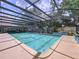 A screened-in pool with rock waterfall feature and landscaped planters at 255 Lake Link Rd, Winter Haven, FL 33884
