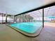 A screened-in pool with in-ground in-ground pool with pool-side patio seating at 255 Lake Link Rd, Winter Haven, FL 33884
