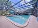 A screened-in pool area featuring a pool-side outdoor dining table and chairs at 255 Lake Link Rd, Winter Haven, FL 33884