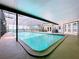 A screened-in in-ground pool with covered pool-side patio seating at 255 Lake Link Rd, Winter Haven, FL 33884