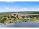 Stunning aerial view of waterfront homes and community with lush greenery and blue skies at 2731 State Road 557, Lake Alfred, FL 33850