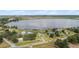 Aerial view of a lakeside property with a sprawling lawn and private driveway at 2731 State Road 557, Lake Alfred, FL 33850