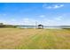 Expansive backyard featuring a covered dock, beautiful lake view, and ample space for outdoor enjoyment at 2731 State Road 557, Lake Alfred, FL 33850