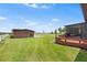 Lush backyard with a deck, large storage shed, and views of the serene lake at 2731 State Road 557, Lake Alfred, FL 33850