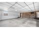 Large unfinished basement provides ample storage with brick accents and an exterior door at 2731 State Road 557, Lake Alfred, FL 33850