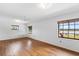 Bedroom featuring a hardwood floor, ceiling fan, and large windows offering plenty of natural light at 2731 State Road 557, Lake Alfred, FL 33850