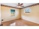 Bright bedroom features a ceiling fan, two windows, neutral walls, and attractive trim at 2731 State Road 557, Lake Alfred, FL 33850