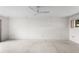 Expansive room showcasing plush carpet, neutral wall, and ample natural light at 2731 State Road 557, Lake Alfred, FL 33850