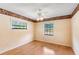 Bright bedroom featuring floral wallpaper, wood flooring, and large windows at 2731 State Road 557, Lake Alfred, FL 33850