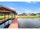 Private dock with seating area extends into a lake, providing tranquil waterfront access at 2731 State Road 557, Lake Alfred, FL 33850