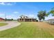 Well-maintained two-story home with lush front yard and ample parking offers a comfortable living space at 2731 State Road 557, Lake Alfred, FL 33850
