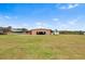 Large grassy backyard featuring a detached garage at 2731 State Road 557, Lake Alfred, FL 33850