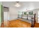 Open hallway area with hardwood floors and neutral colors, offering plenty of natural light at 2731 State Road 557, Lake Alfred, FL 33850