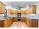 Bright kitchen with wood cabinetry, tile backsplash, stainless appliances, and granite countertops at 2731 State Road 557, Lake Alfred, FL 33850