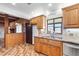 Traditional kitchen with wood cabinets, brick accents, tile backsplash, stainless appliances and granite countertops at 2731 State Road 557, Lake Alfred, FL 33850
