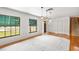 Spacious living room with hardwood floors, white rug, and windows offering natural light at 2731 State Road 557, Lake Alfred, FL 33850