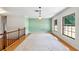 Open living space featuring hardwood floors, white rug, and plenty of natural light at 2731 State Road 557, Lake Alfred, FL 33850