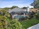 Aerial view of the screened-in pool and lush backyard, perfect for relaxation and entertainment at 2987 Plantation Rd, Winter Haven, FL 33884