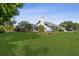 Expansive backyard featuring a well-maintained lawn, mature trees, and a screened lanai at 2987 Plantation Rd, Winter Haven, FL 33884