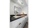 Stylish bar area with a black countertop, white cabinets, and a unique mirror at 2987 Plantation Rd, Winter Haven, FL 33884