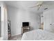 Bright bedroom with modern flooring, neutral walls, ceiling fan, and a television stand at 2987 Plantation Rd, Winter Haven, FL 33884