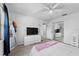 Modern bedroom with updated flooring, ceiling fan, dresser, and large mirror at 2987 Plantation Rd, Winter Haven, FL 33884