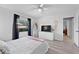 Sunlit bedroom boasts sleek flooring, ceiling fan, dresser, and darkening curtains at 2987 Plantation Rd, Winter Haven, FL 33884