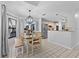 Bright dining area with tile floors, a farmhouse-style table, and stainless steel appliances in adjacent kitchen at 2987 Plantation Rd, Winter Haven, FL 33884