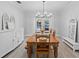 Dining room with wood table, white accents, chandelier, and access to the pool at 2987 Plantation Rd, Winter Haven, FL 33884