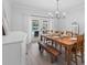 Dining room features a rustic wood table set for dining with view to the outdoor pool at 2987 Plantation Rd, Winter Haven, FL 33884