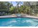 Enjoy this close up view of the brick-faced hot tub surrounded by lush landscaping at 2987 Plantation Rd, Winter Haven, FL 33884